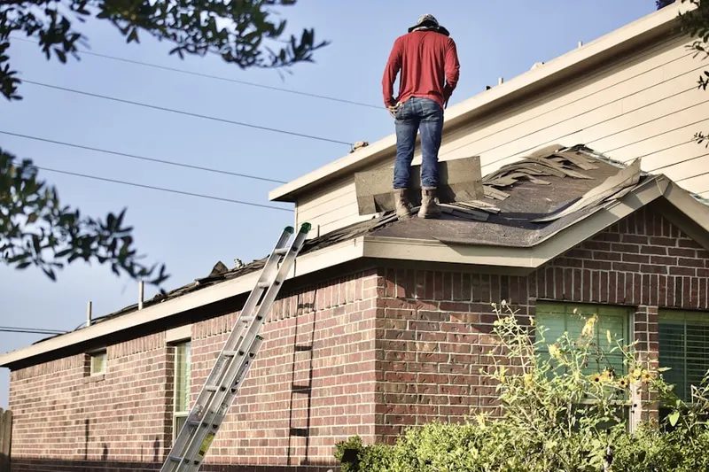 Professional roofer working on a residential roof in MacDill Estates